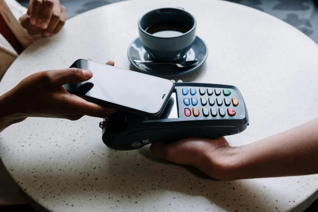 Person uses virtual card on their phone's digital wallet to make contactless payment.