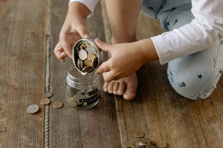 A child collects money in a jar instead of using a bank account.