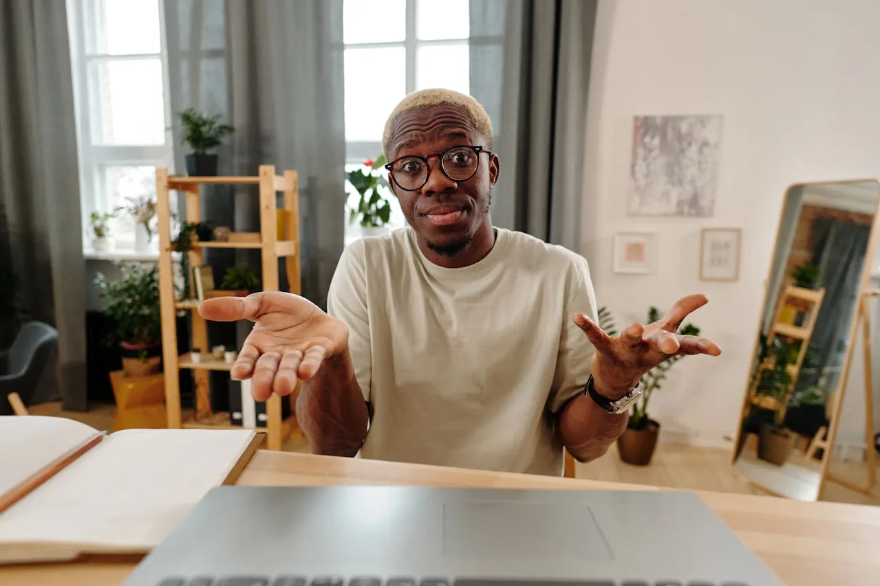 Man looking confused in front of a computer about overdraft protection.