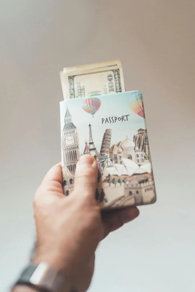 A travel wallet containing cash and a passport, organized for easy access during journeys.